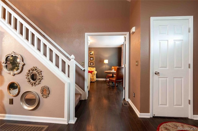 12242 Bannock Cir Unit D, Denver, CO 80234 - entrance foyer featuring baseboards, dark wood finished floors, and stairs