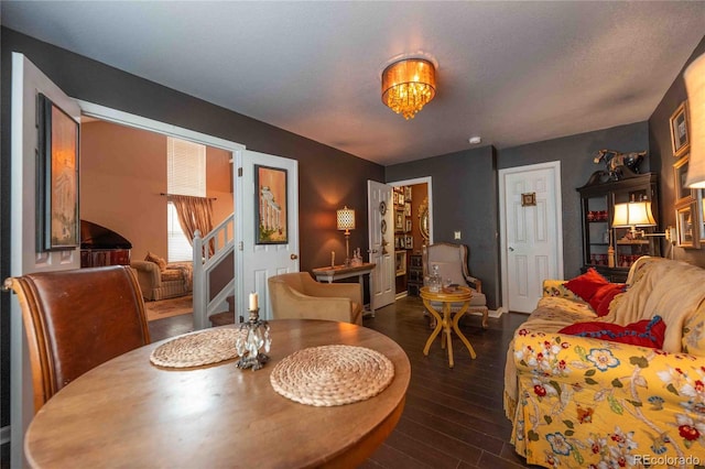 12242 Bannock Cir Unit D, Denver, CO 80234 - dining room featuring dark wood-type flooring, stairs, and a chandelier