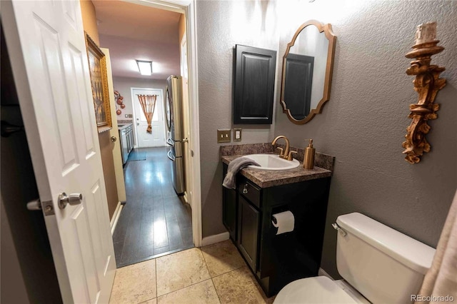 12242 Bannock Cir Unit D, Denver, CO 80234 - bathroom featuring vanity, toilet, tile patterned floors, and baseboards