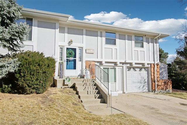 view of front of house featuring concrete driveway, a garage, and board and batten siding