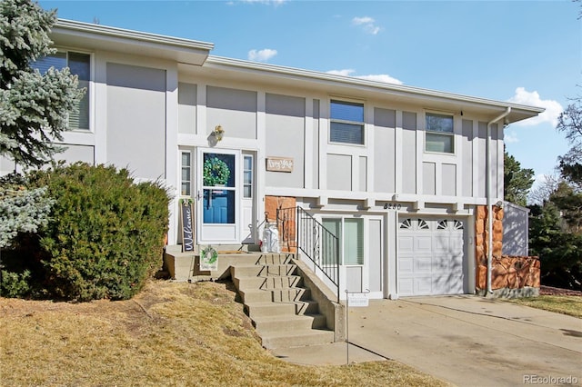 view of front facade with an attached garage, board and batten siding, and driveway