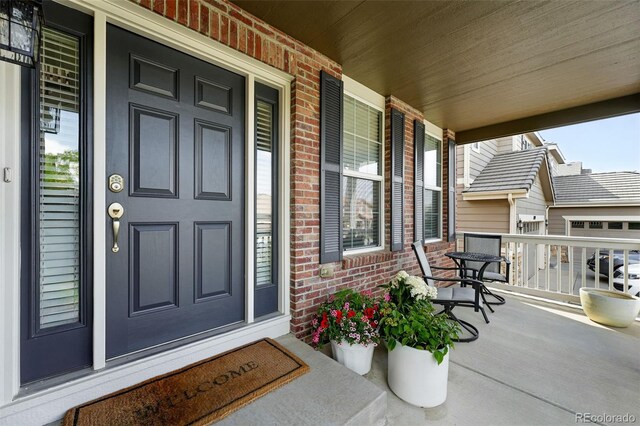 11985 Singing Winds St, Parker, CO 80138 - property entrance featuring brick siding and covered porch