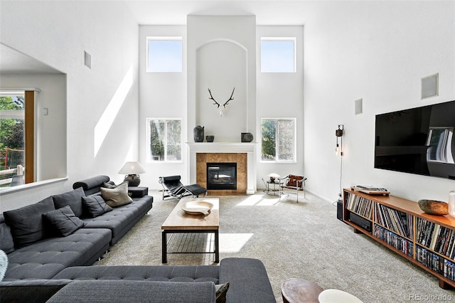 11985 Singing Winds St, Parker, CO 80138 - carpeted living room featuring a high ceiling and a tiled fireplace