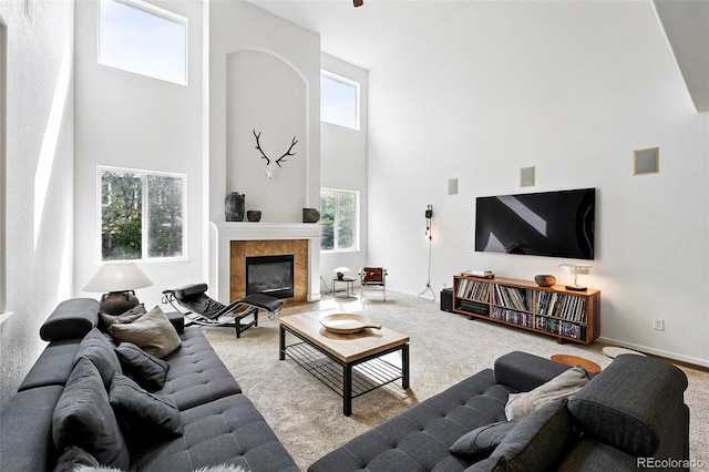 11985 Singing Winds St, Parker, CO 80138 - living area featuring a high ceiling, carpet floors, a fireplace, and baseboards