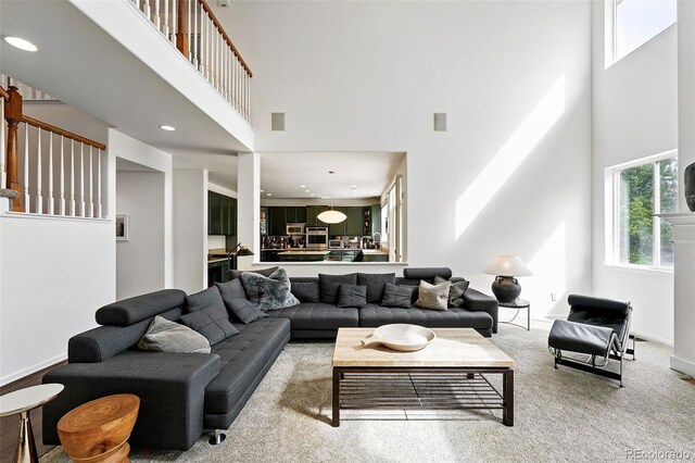 11985 Singing Winds St, Parker, CO 80138 - living room featuring a towering ceiling, recessed lighting, light colored carpet, and stairway