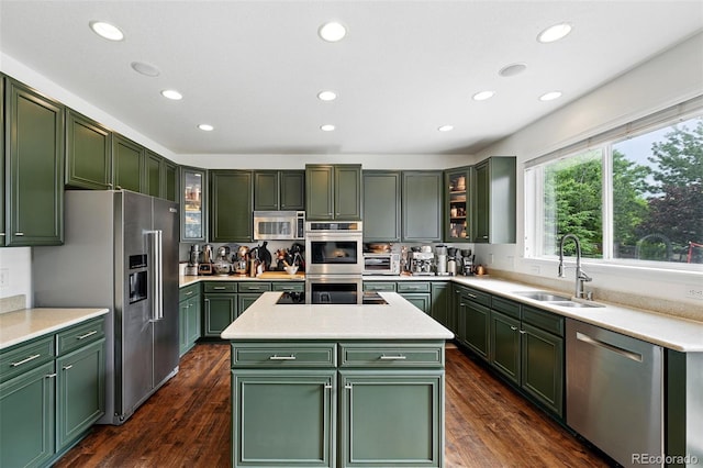 11985 Singing Winds St, Parker, CO 80138 - kitchen with green cabinetry, appliances with stainless steel finishes, recessed lighting, a sink, and light countertops