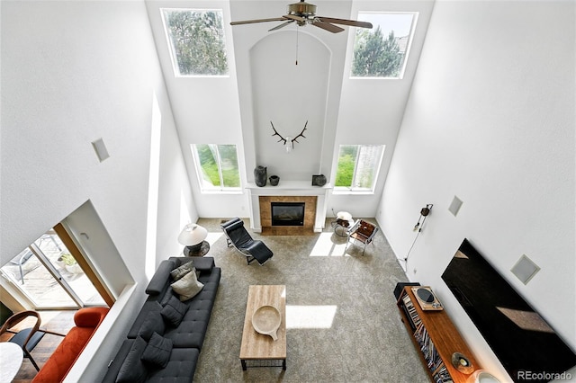 11985 Singing Winds St, Parker, CO 80138 - carpeted living room with a towering ceiling, a tile fireplace, and ceiling fan