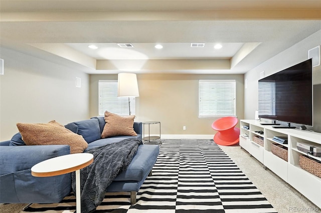 11985 Singing Winds St, Parker, CO 80138 - living room with a tray ceiling, light colored carpet, healthy amount of natural light, and recessed lighting