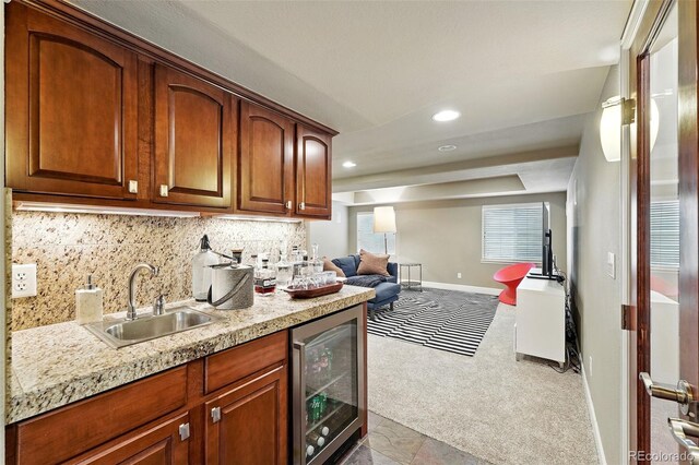 11985 Singing Winds St, Parker, CO 80138 - kitchen with wine cooler, a sink, open floor plan, carpet floors, and tasteful backsplash