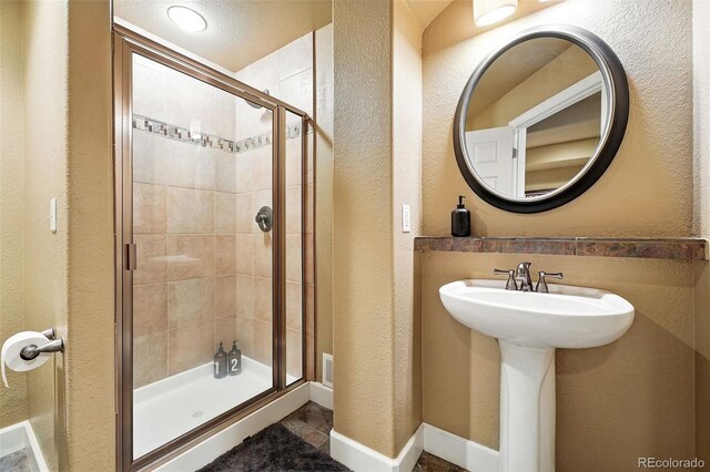 11985 Singing Winds St, Parker, CO 80138 - bathroom with a shower stall and a textured wall