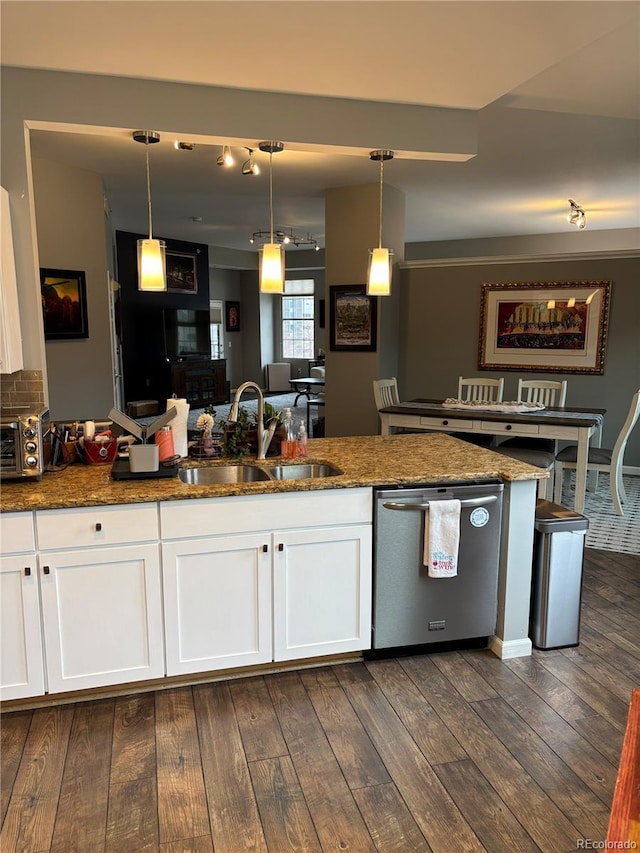 kitchen featuring dark wood-style floors, hanging light fixtures, white cabinetry, a sink, and dishwasher