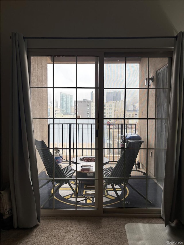 entryway featuring a view of city and carpet