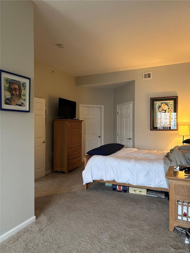 carpeted bedroom with visible vents and baseboards
