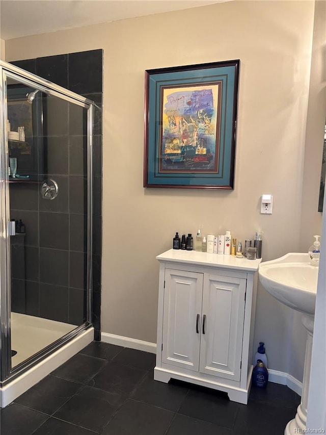 bathroom with tile patterned flooring, a shower stall, and baseboards
