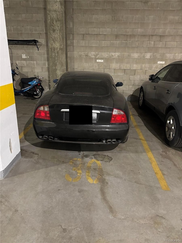 parking garage featuring concrete block wall