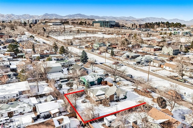 snowy aerial view with a mountain view