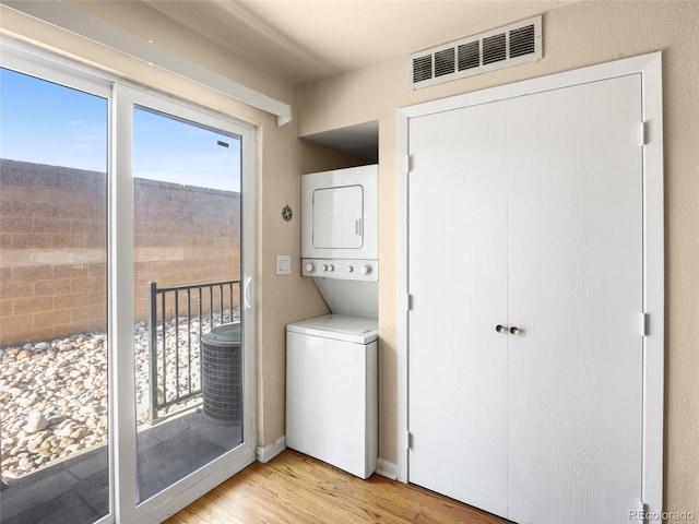 61 S Sable Blvd Unit C15, Aurora, CO 80012 - washroom with stacked washer / drying machine and light wood-style floors