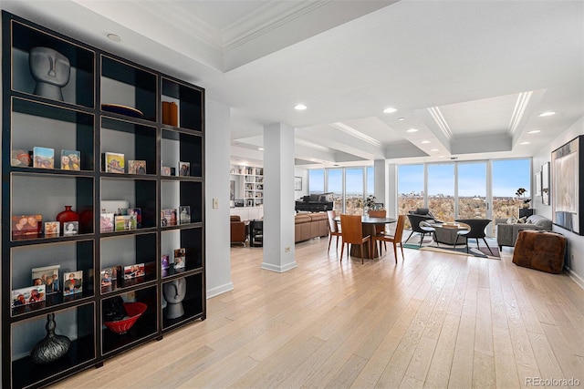 interior space with ornamental molding, a tray ceiling, hardwood / wood-style floors, and recessed lighting