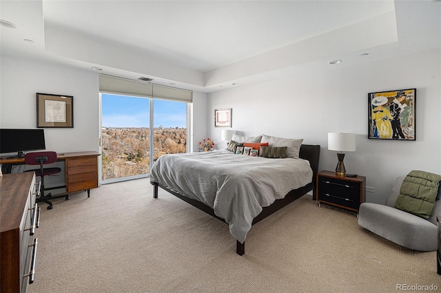 carpeted bedroom with access to exterior, visible vents, a raised ceiling, and recessed lighting