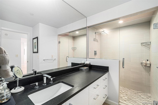 bathroom featuring a stall shower and vanity