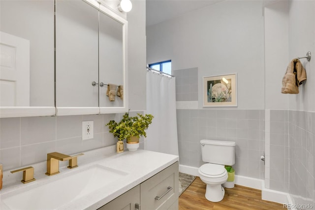 748 Elati St, Denver, CO 80204 - bathroom featuring tile walls, vanity, toilet, wood finished floors, and curtained shower