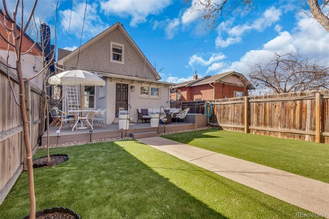 748 Elati St, Denver, CO 80204 - rear view of property featuring a deck and brick siding