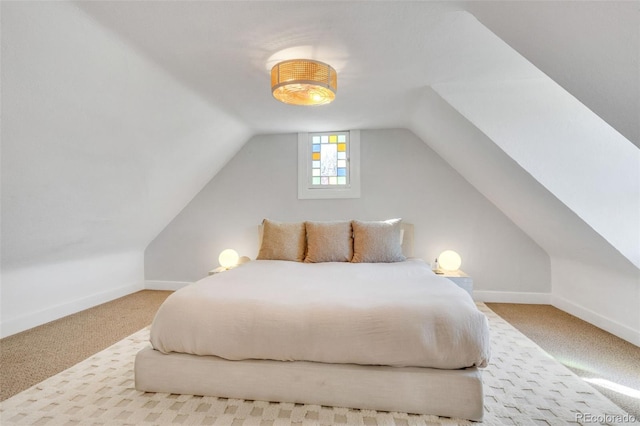 748 Elati St, Denver, CO 80204 - bedroom with lofted ceiling, carpet, and baseboards