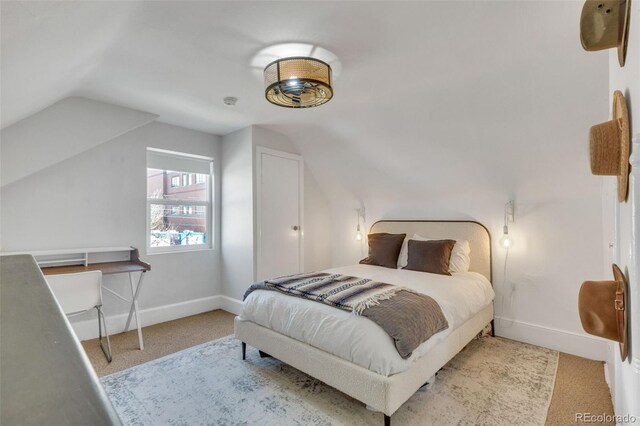748 Elati St, Denver, CO 80204 - bedroom with lofted ceiling, carpet, and baseboards