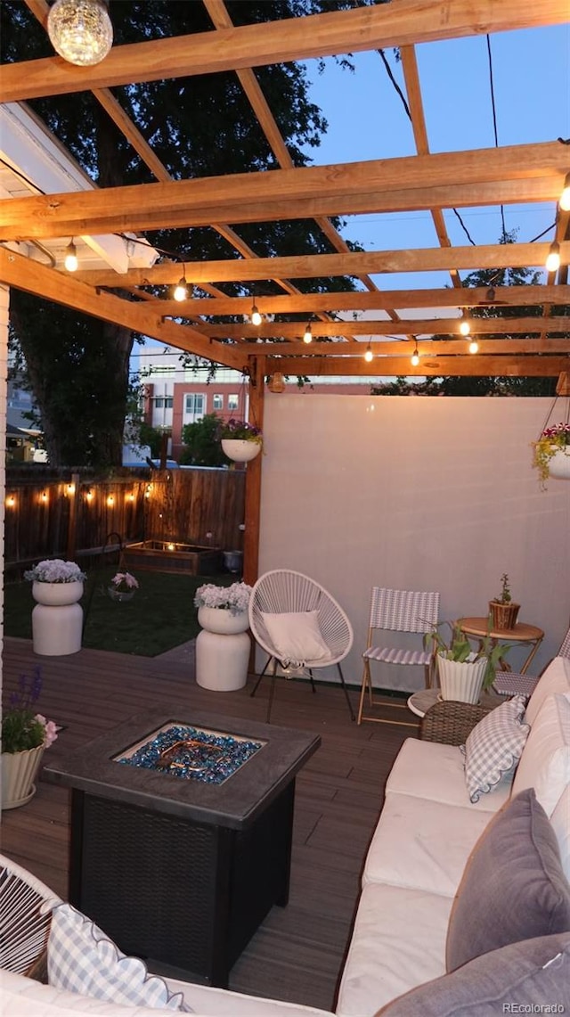 748 Elati St, Denver, CO 80204 - wooden terrace featuring a fenced backyard, a pergola, and an outdoor living space with a fire pit