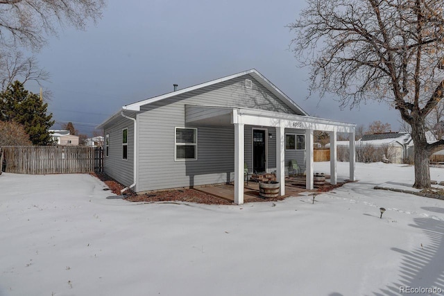 view of snow covered rear of property