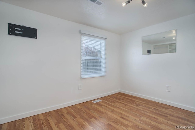 unfurnished room featuring wood-type flooring