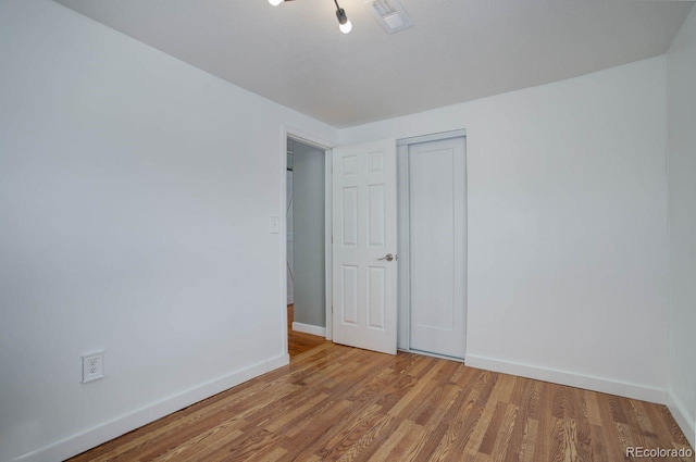 unfurnished room with hardwood / wood-style flooring