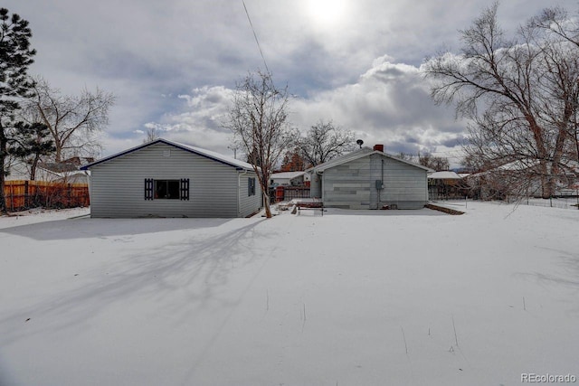 view of snow covered rear of property