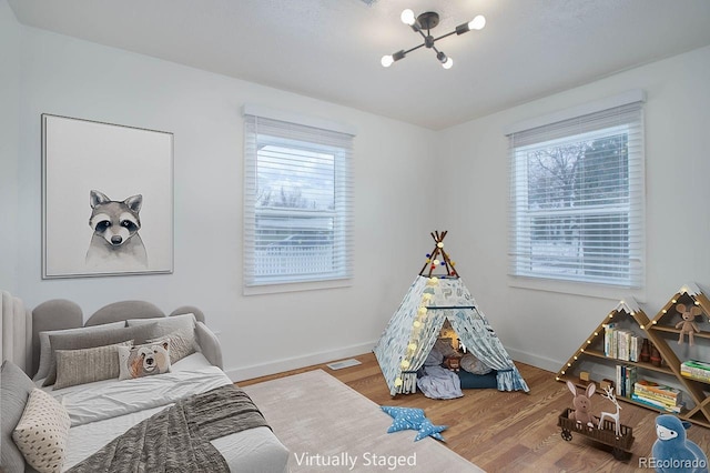 bedroom featuring hardwood / wood-style floors and multiple windows