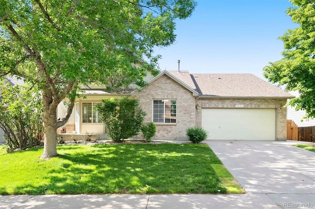 3461 Maple Cir, Brighton, CO 80601 - view of front of property featuring brick siding, an attached garage, driveway, and roof with shingles