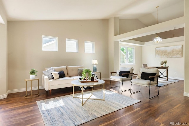 3461 Maple Cir, Brighton, CO 80601 - living room with wood finished floors, baseboards, a chandelier, and high vaulted ceiling