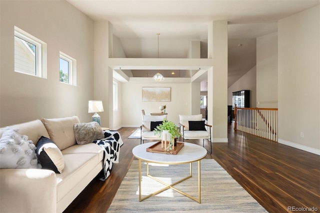 3461 Maple Cir, Brighton, CO 80601 - living area with wood finished floors, high vaulted ceiling, a chandelier, and baseboards