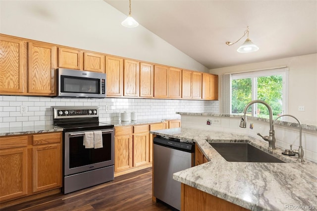 3461 Maple Cir, Brighton, CO 80601 - kitchen featuring appliances with stainless steel finishes, a sink, vaulted ceiling, dark wood-style floors, and tasteful backsplash