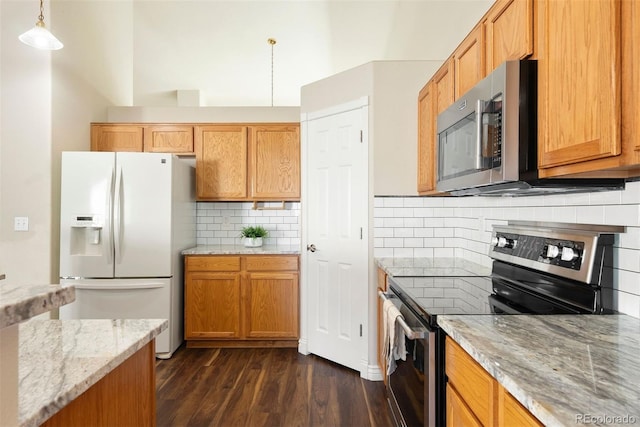 3461 Maple Cir, Brighton, CO 80601 - kitchen featuring stainless steel appliances, dark wood-type flooring, light stone counters, backsplash, and pendant lighting