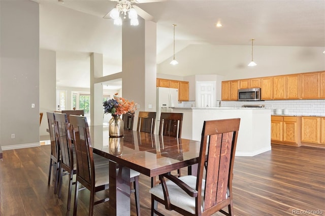 3461 Maple Cir, Brighton, CO 80601 - dining area with dark wood-style flooring, ceiling fan, high vaulted ceiling, and baseboards