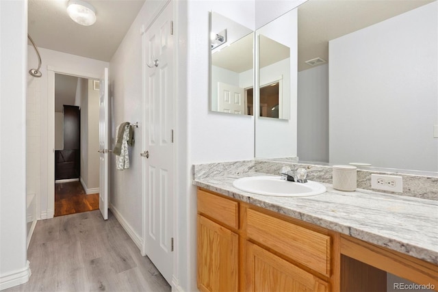 3461 Maple Cir, Brighton, CO 80601 - full bath with vanity, wood finished floors, and baseboards