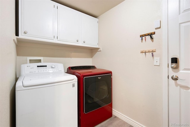 3461 Maple Cir, Brighton, CO 80601 - laundry area with washing machine and clothes dryer, cabinet space, baseboards, and wood finished floors