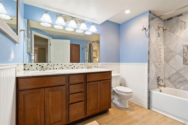 3461 Maple Cir, Brighton, CO 80601 - bathroom featuring wainscoting, double vanity, shower / tub combo, toilet, and wood finished floors