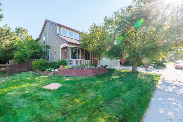 view of front of property featuring a garage, covered porch, and a front yard