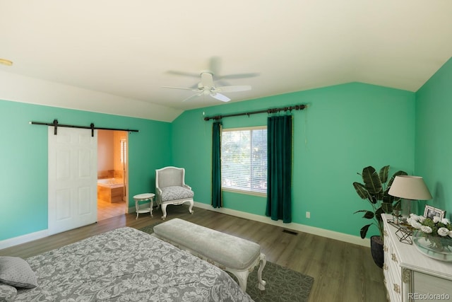 bedroom featuring ceiling fan, vaulted ceiling, a barn door, and wood-type flooring