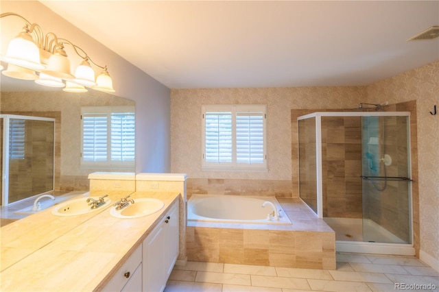 bathroom featuring plus walk in shower, plenty of natural light, and vanity