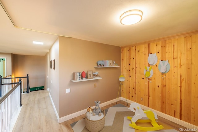 interior space with wood-type flooring and wood walls