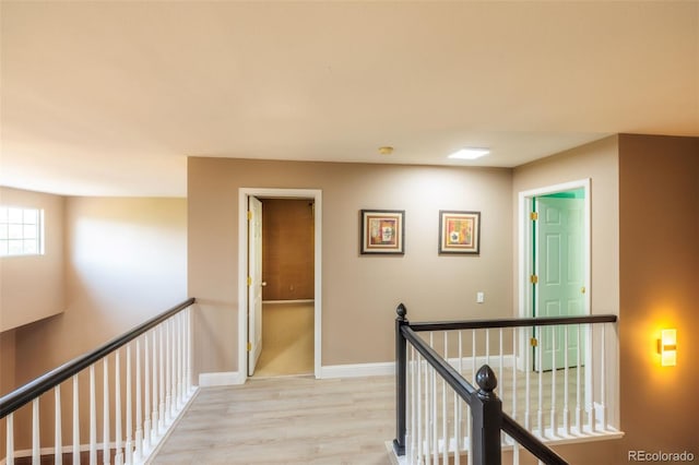 hallway with light hardwood / wood-style flooring