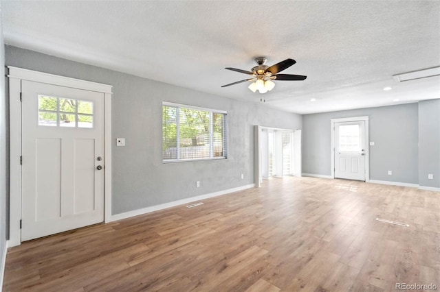 1210 Westend Ave, Colorado Springs, CO 80904 - entrance foyer with light wood-style flooring, healthy amount of natural light, ceiling fan, and a textured ceiling