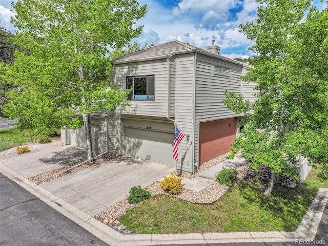 766 Chimney Creek Dr, Golden, CO 80401 - view of front of property featuring concrete driveway, a chimney, and a garage